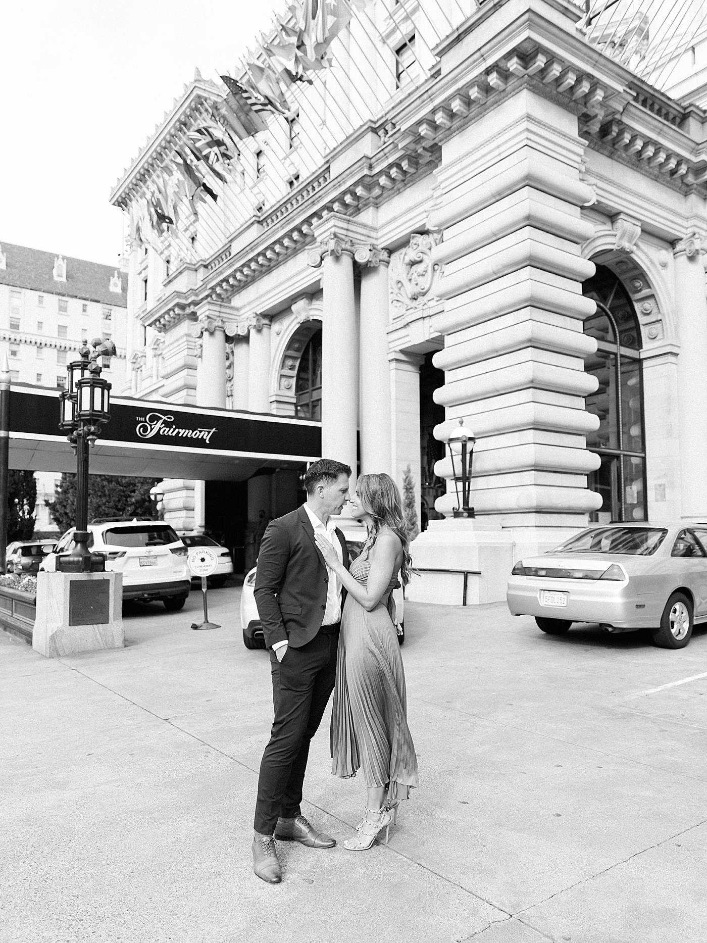 Couple kissing near The Fairmont during their San Francisco engagement session | Photo by Diane Sotero
