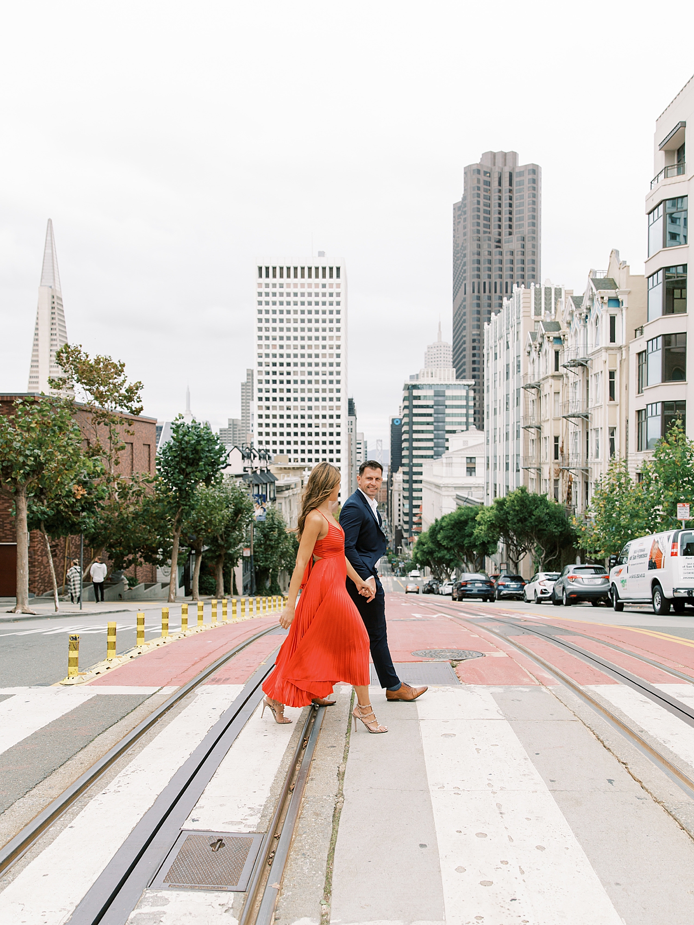 Couple in black and red walking through San Francisco | Photo by Diane Sotero