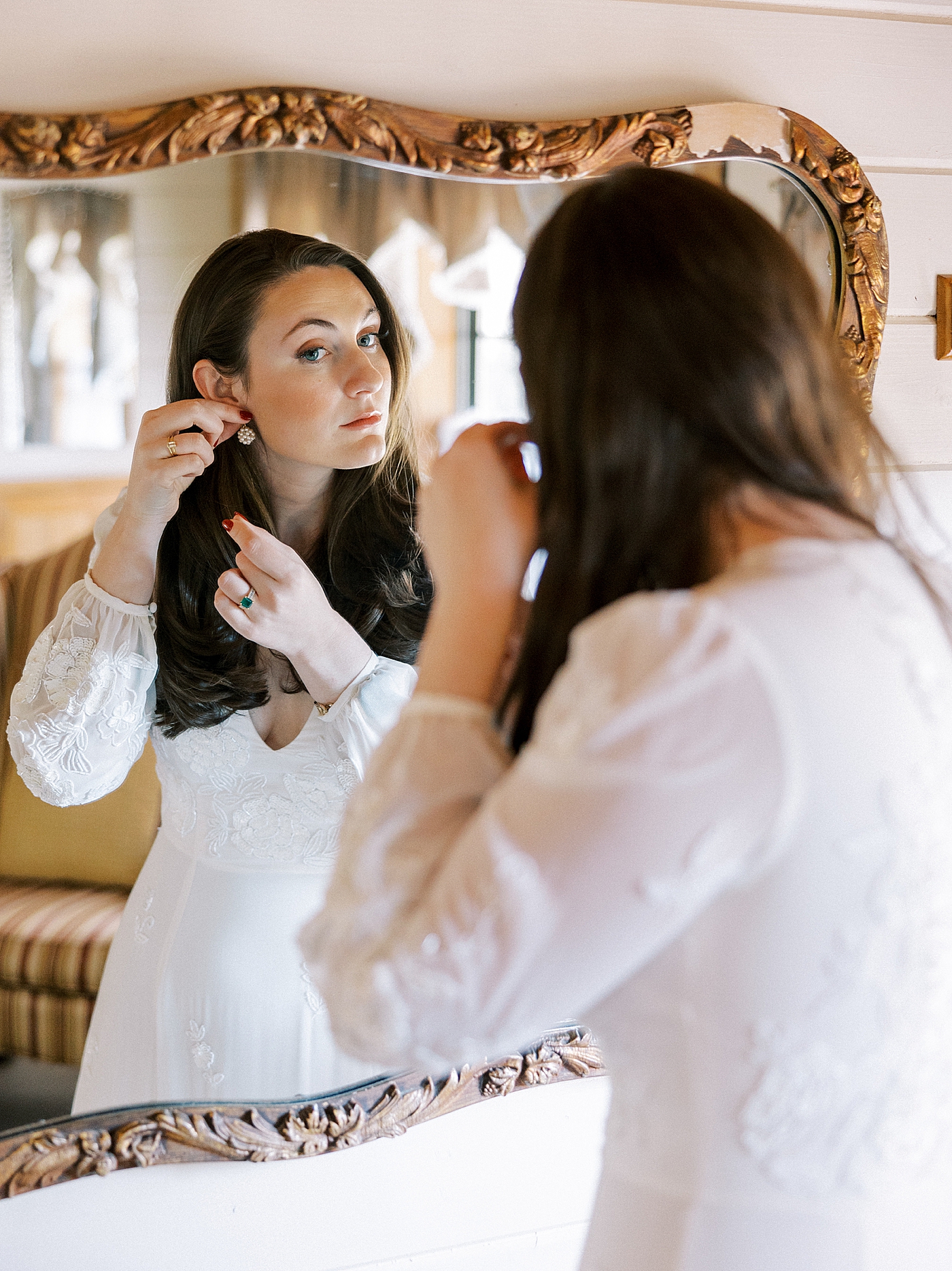 Bride putting in her earrings | Photo by Diane Sotero Photography