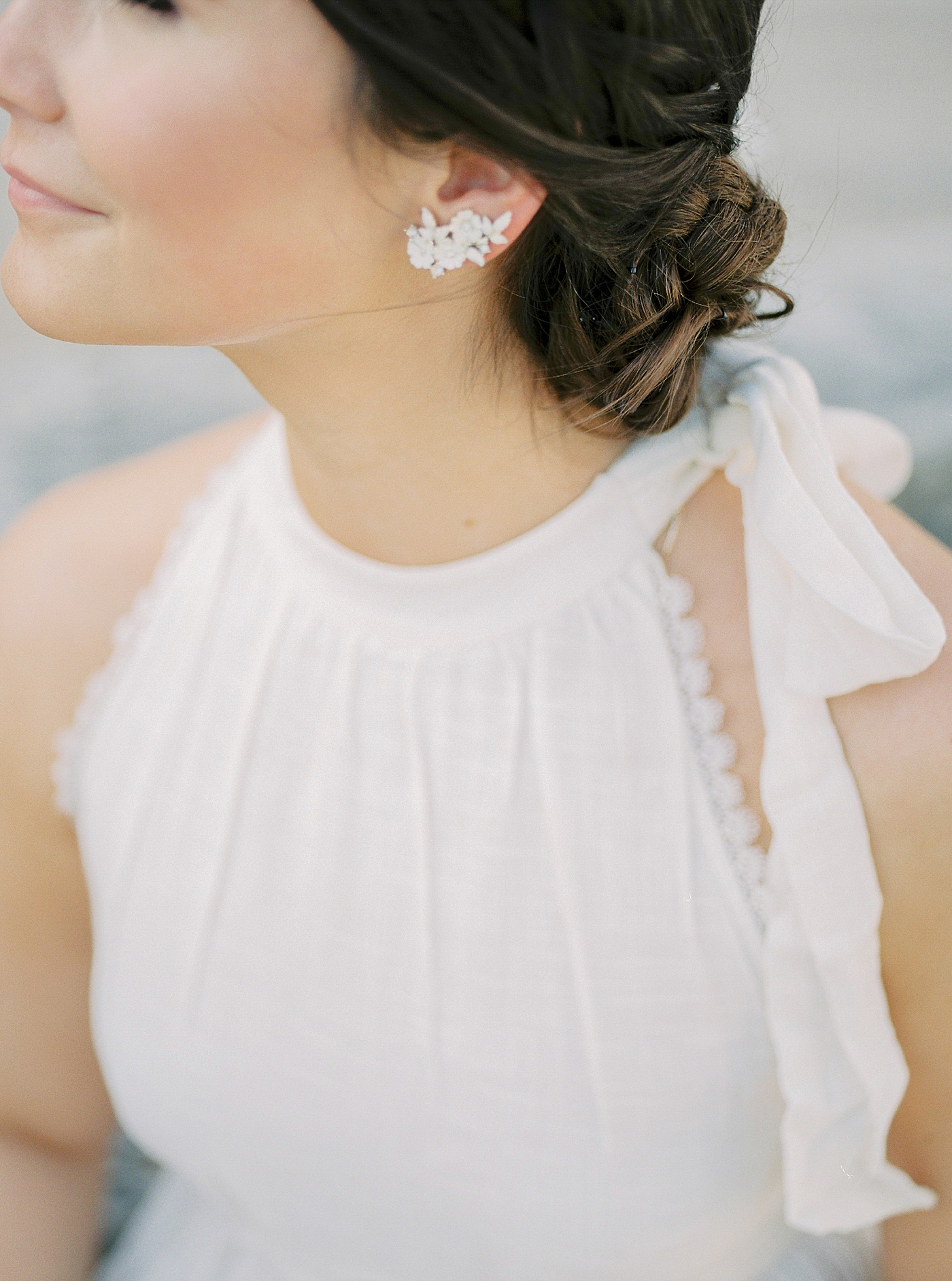 Detail of bride's earring and hair in an updo | Photo by Diane Sotero 