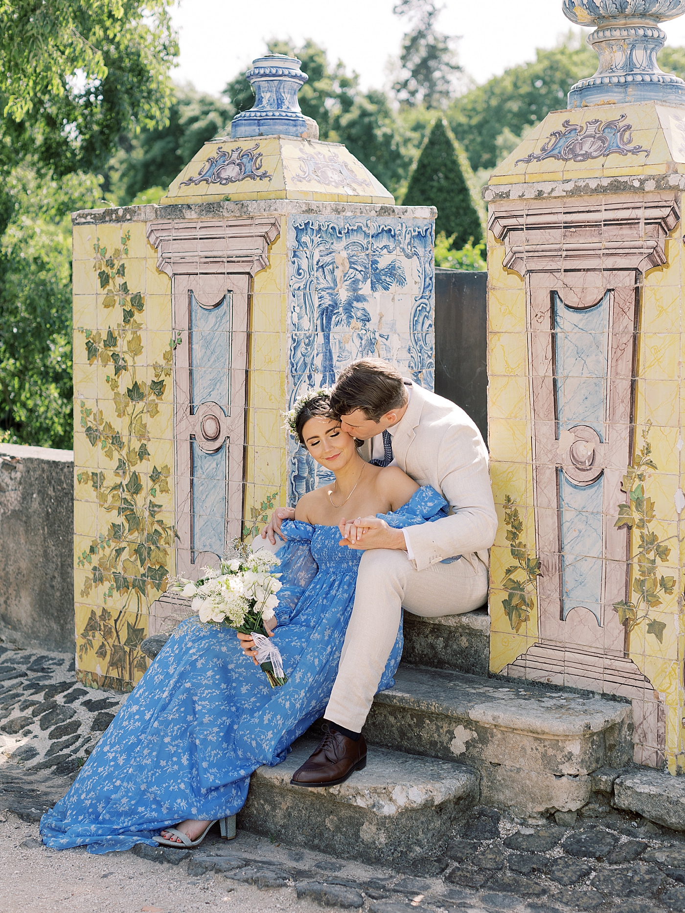 Couple in blue and cream sitting outside Palacio de Queluz | Photo by Diane Sotero 