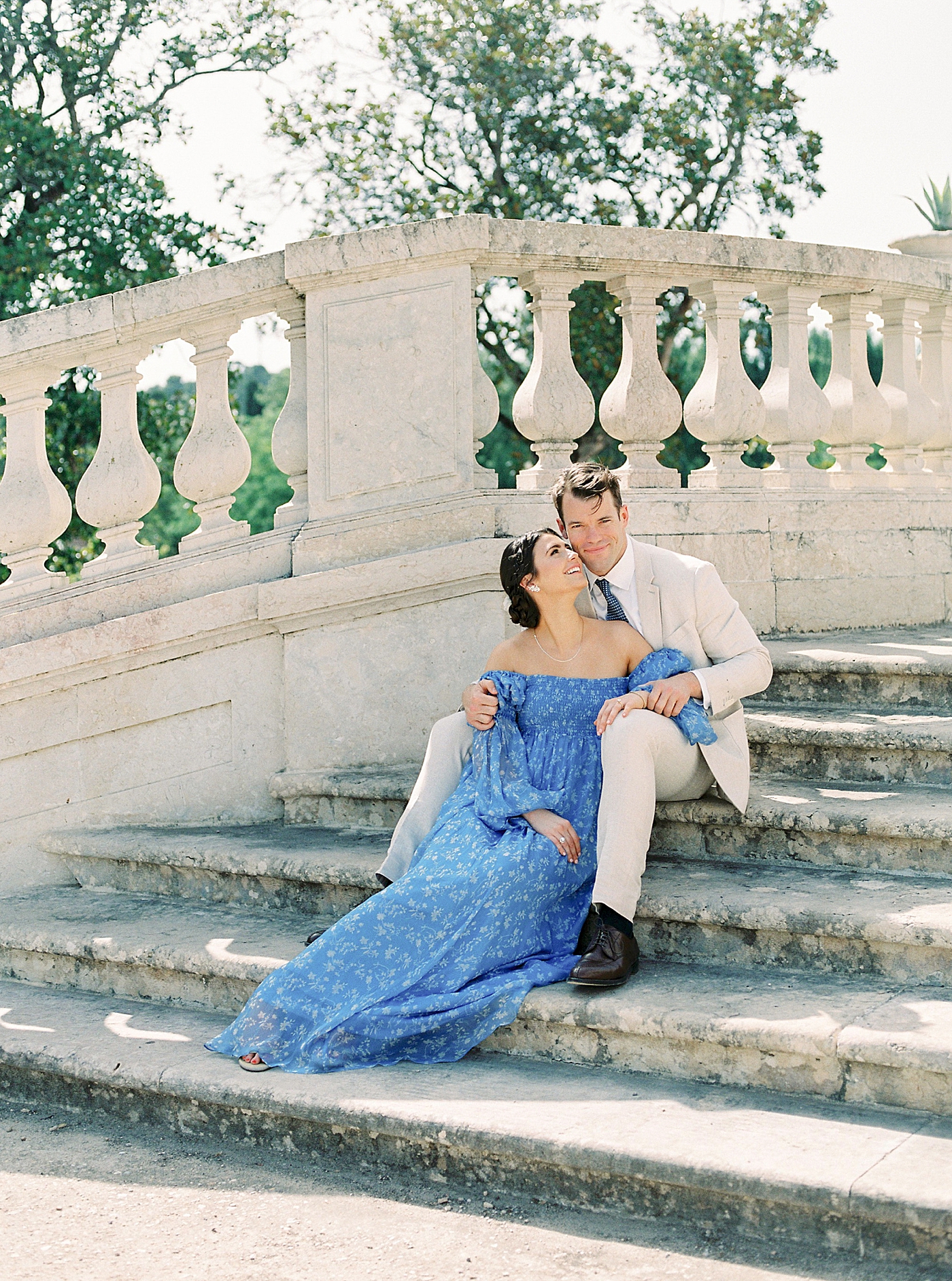 Couple snuggling sitting on steps outside Palacio de Queluz | Photo by Diane Sotero 