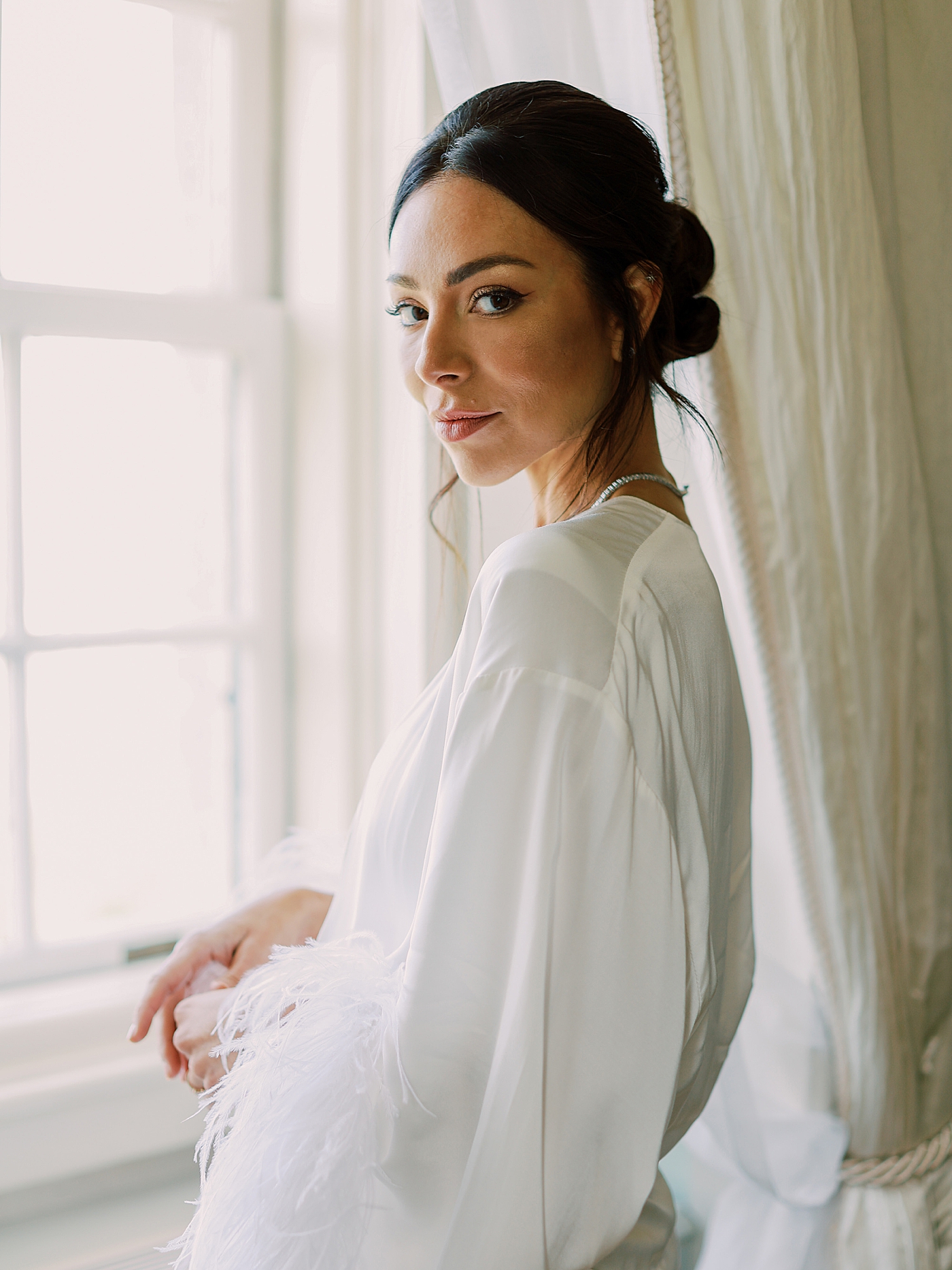 Bride in a robe with frill sleeves | Image by Diane Sotero Photography