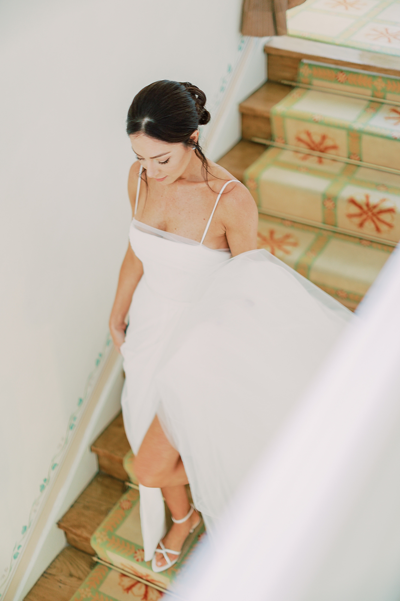 Bride in a gown walking down the stairs | Image by Diane Sotero Photography