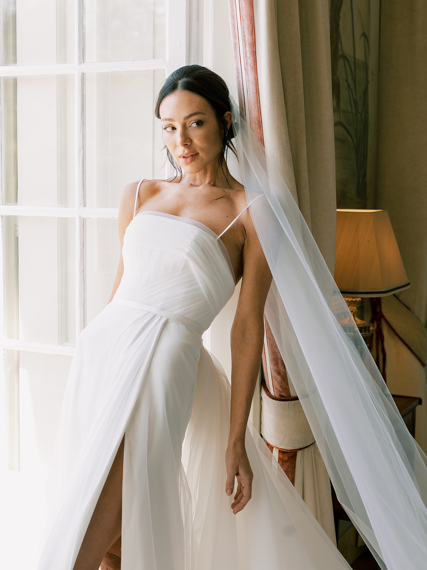 Bride leaning in a doorway | Image by Diane Sotero Photography