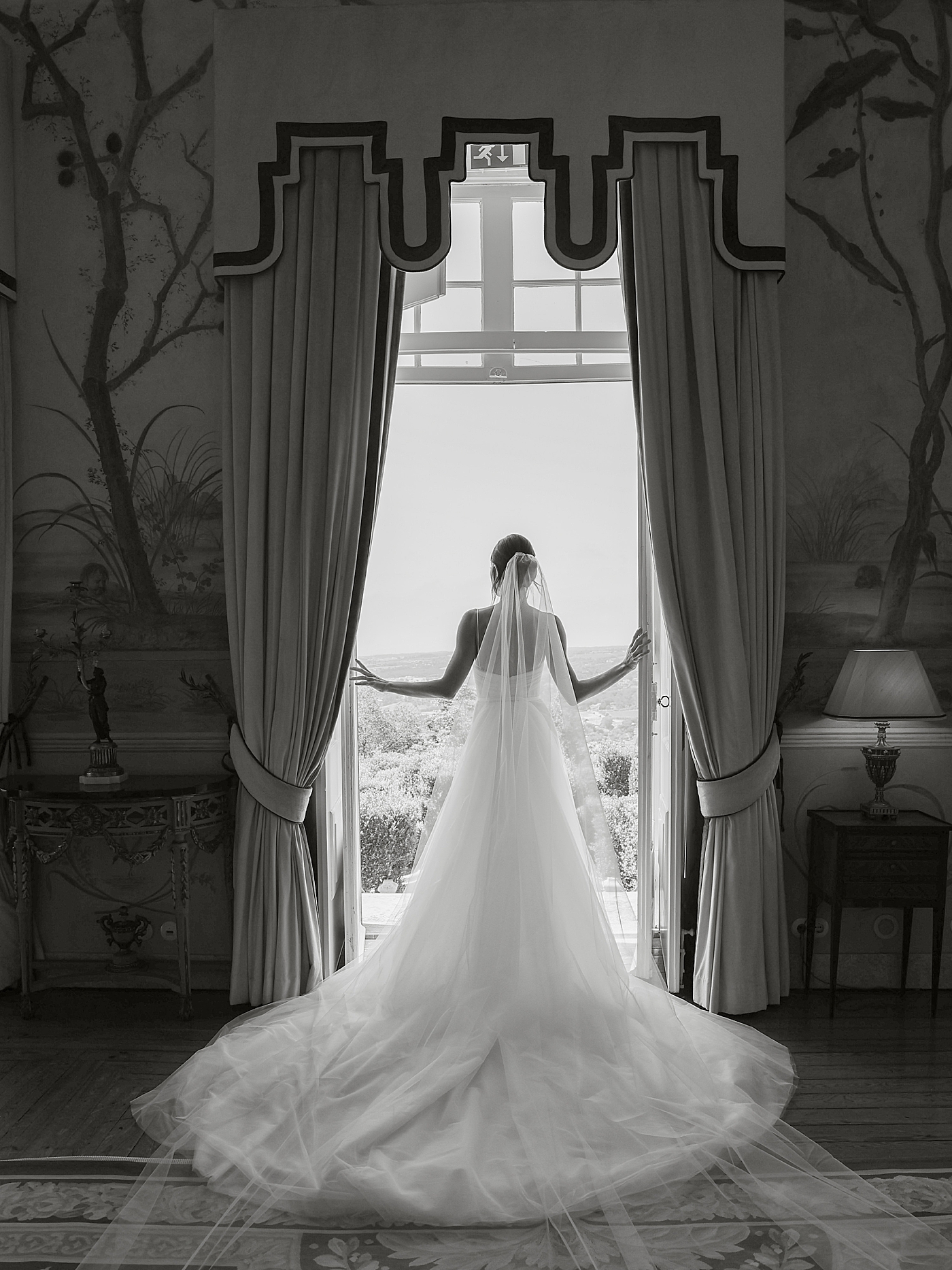 Black and white image of bride by a doorway | Image by Diane Sotero Photography