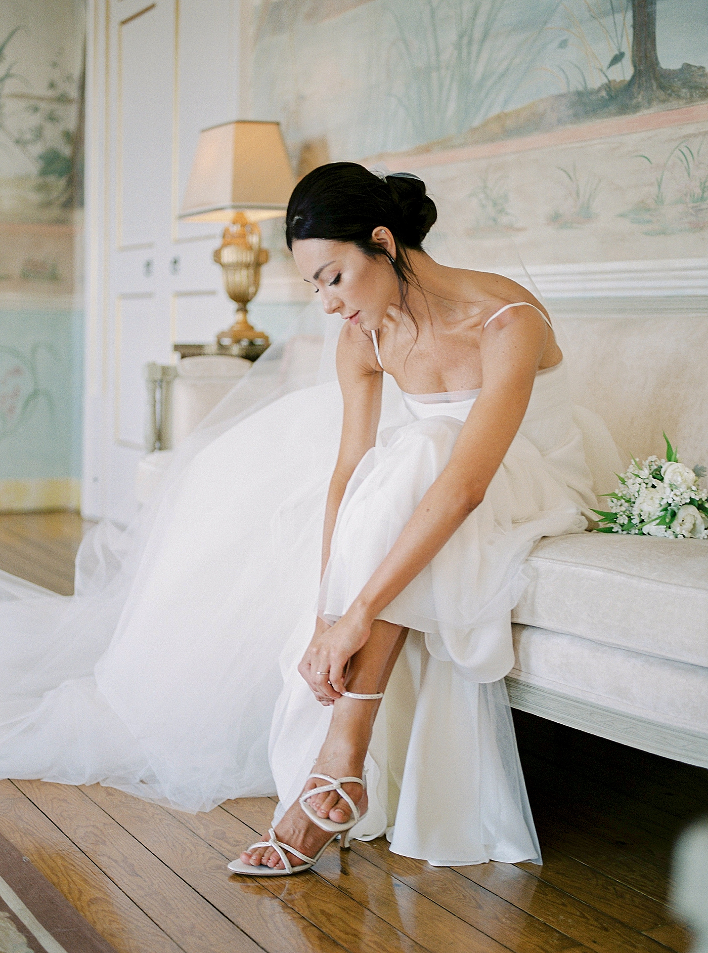 Bride putting on her custom shoes | Image by Diane Sotero Photography