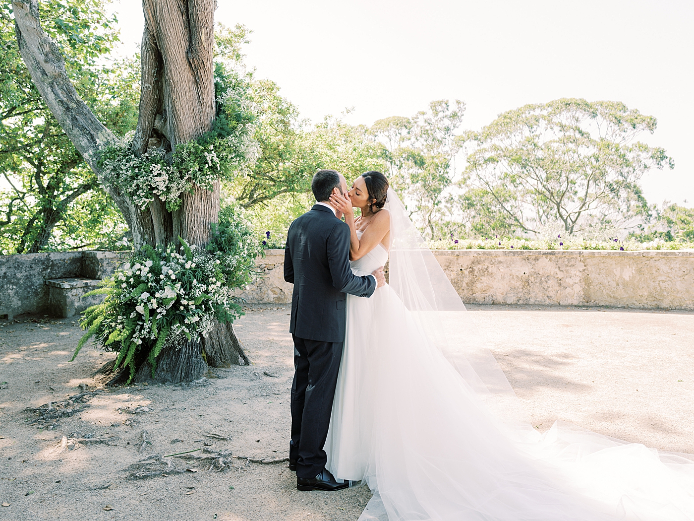 Bride and groom sharing their first kiss | Image by Diane Sotero Photography