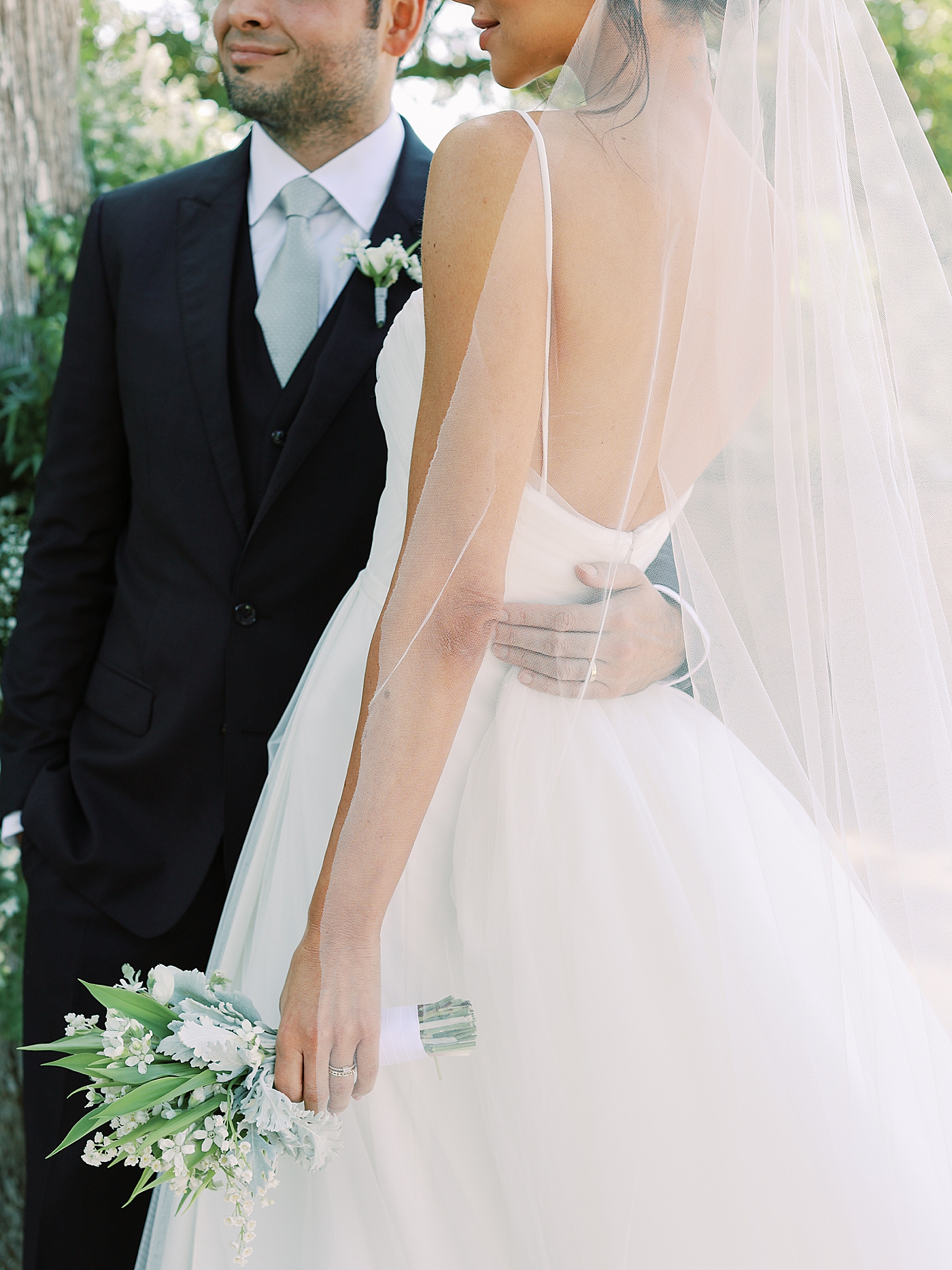 Detail of grooms hand around brides waist | Image by Diane Sotero Photography