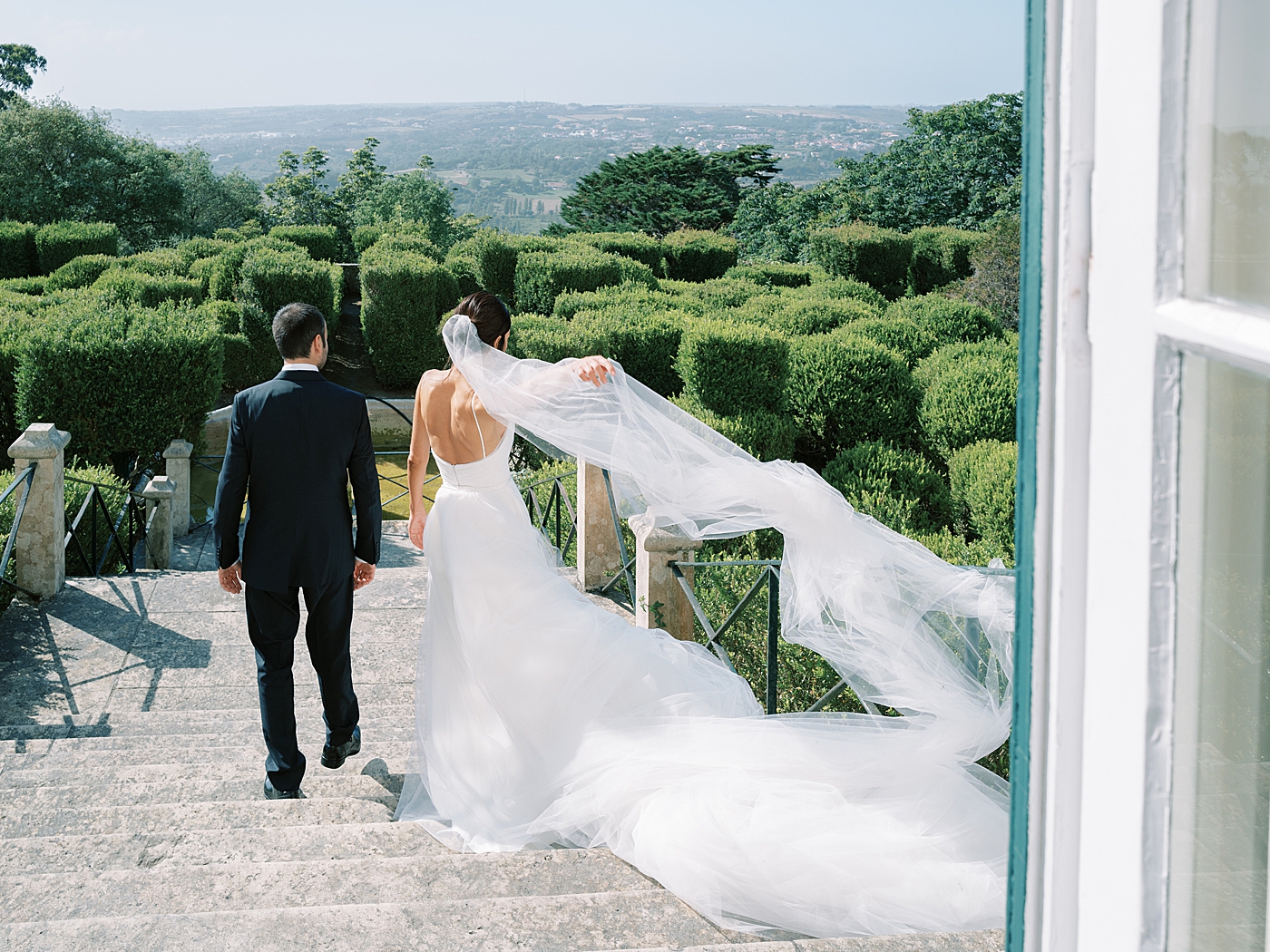 Bride and groom walking down a path | Image by Diane Sotero Photography