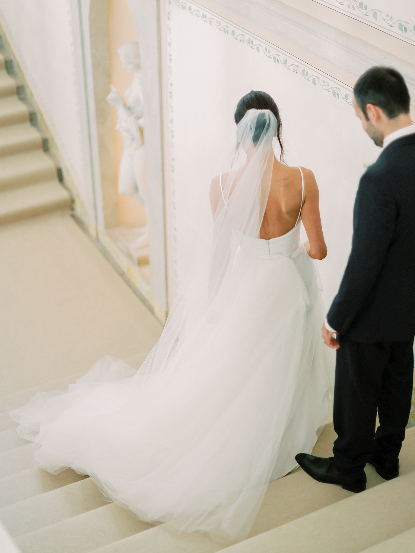 Bride and groom walking down stairs | Image by Diane Sotero Photography