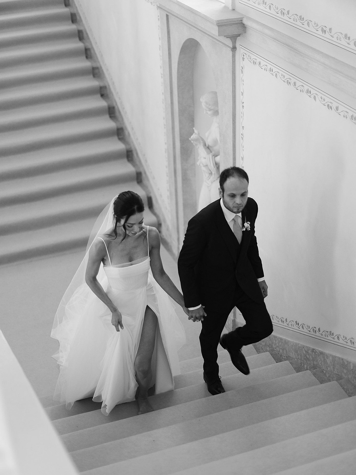 Black and white image of bride and groom on stairs | Image by Diane Sotero Photography