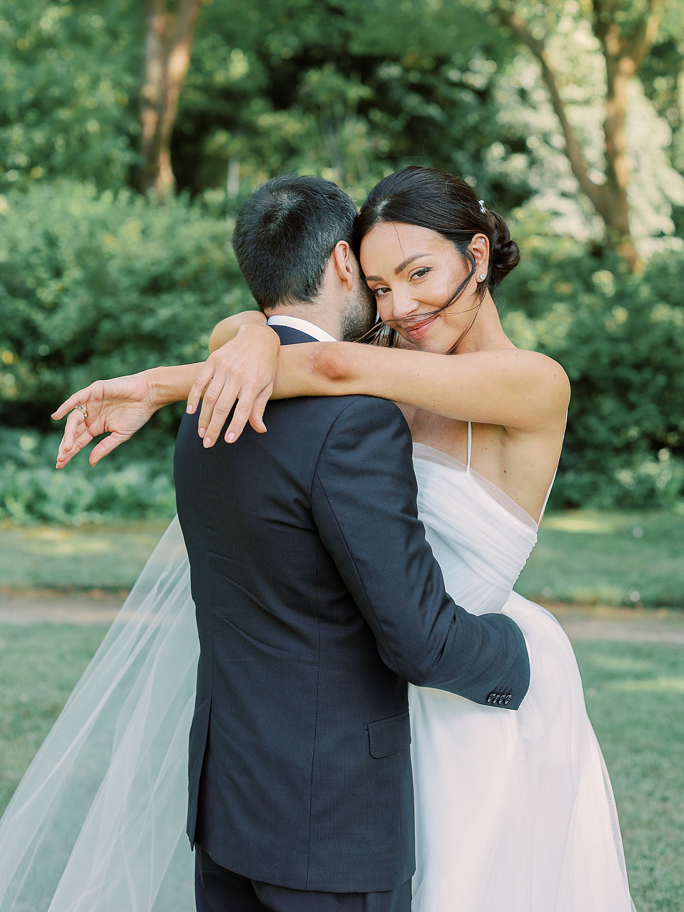 Bride with her arms draped over groom | Image by Diane Sotero Photography