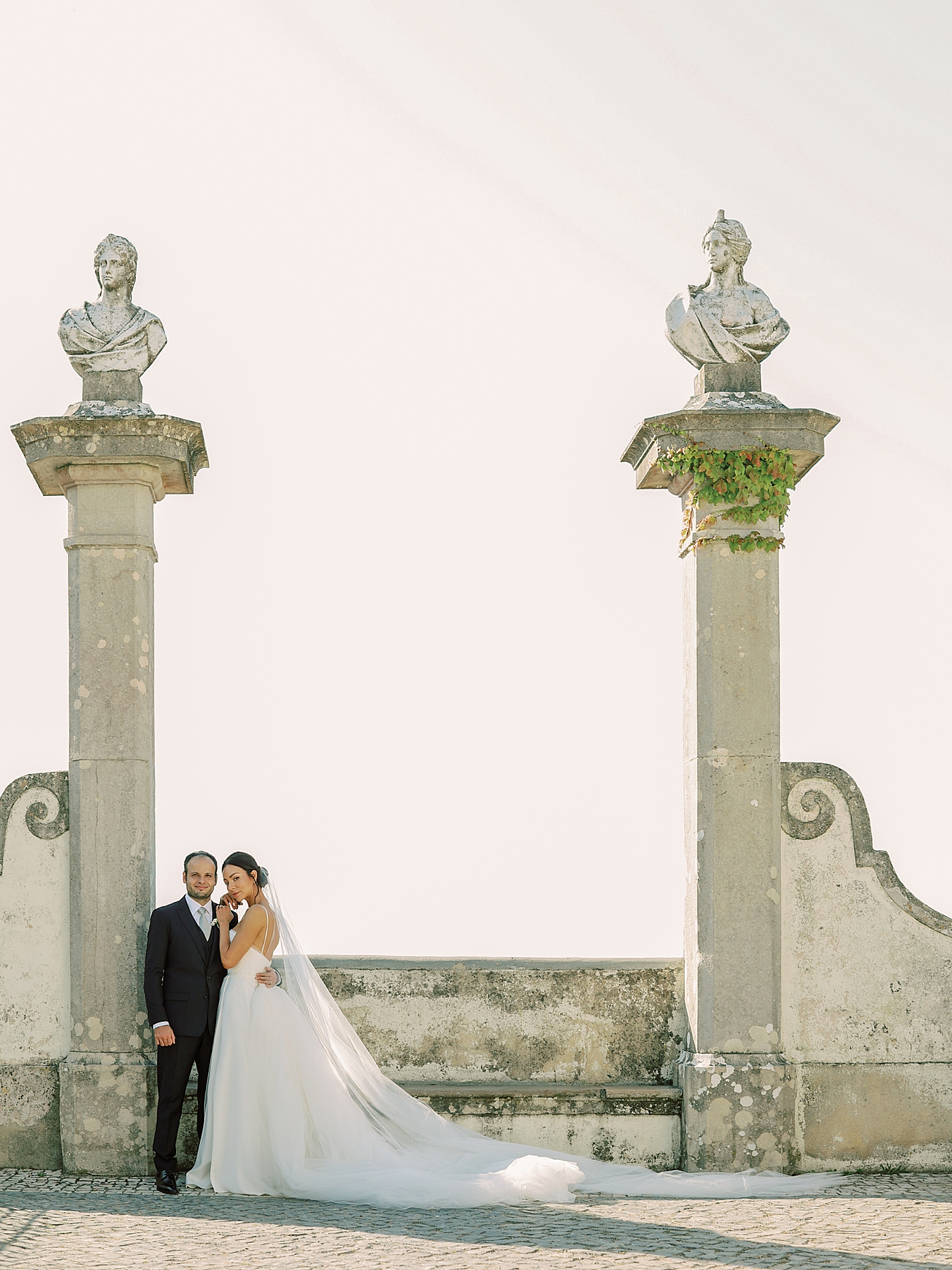 Bride and groom embracing near monument | Image by Diane Sotero Photography