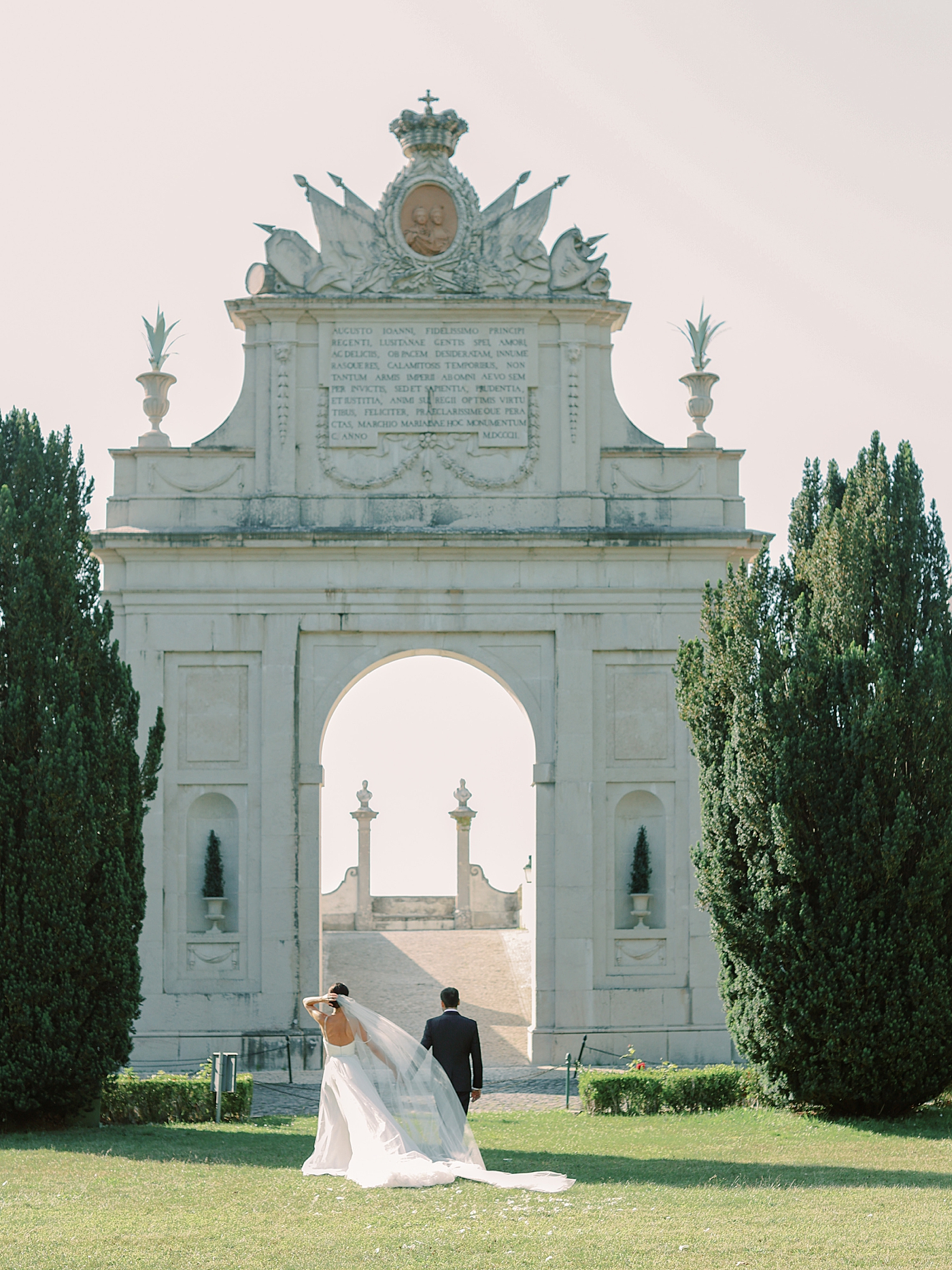 Bride and groom walking toward a monument | Photo by Diane Sotero Photography
