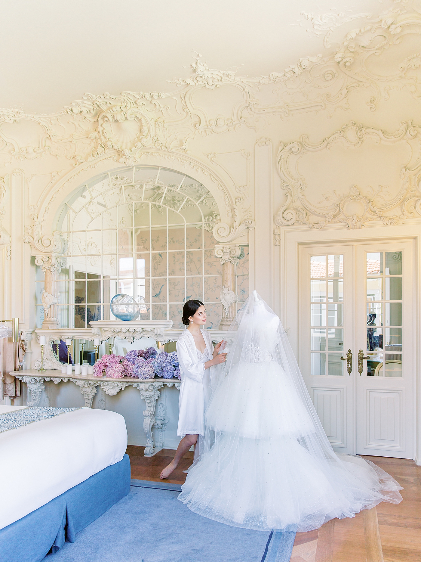Bride adjusting her couture gown in her getting ready room | Image by Diane Sotero 
