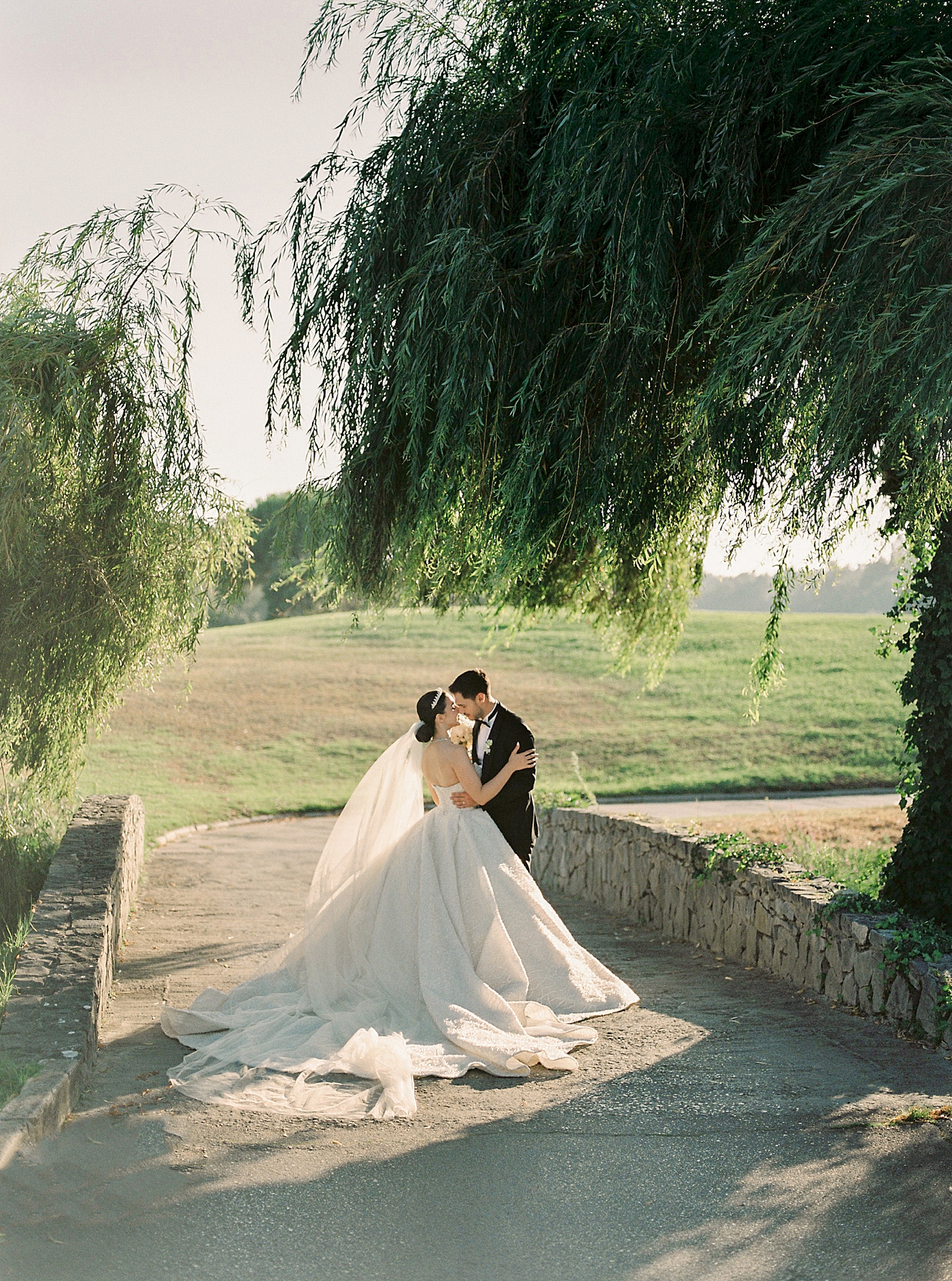 Bride and groom on a pathway under trees | Image by Diane Sotero